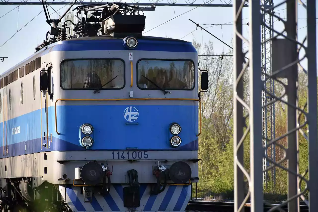 Close up of a cargo train moving on the rails.