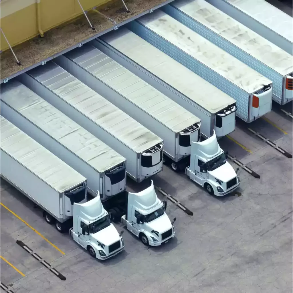 Multiple trucks parked at a loading station.